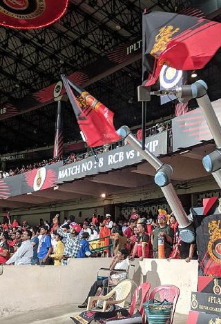 Image Showing The Collaborative Robot Raising The Team Flags and Cheering Like Audience.