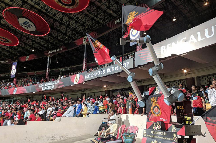 Image Showing The Collaborative Robot Raising The Team Flags and Cheering Like Audience.